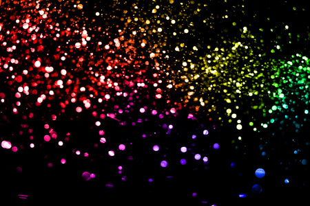 christmas multicolor sparkle glitter explosion dust particles background with bokeh, color holiday happy new year and valentine day love, relationship conceptの写真素材