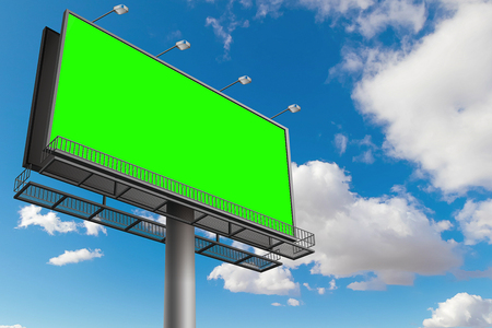empty billboard with chroma key green screen, on blue sky with clouds, advertisement conceptの写真素材