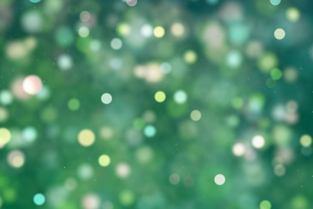 christmas digital glitter sparks green yellow color particles bokeh flowing on green background, holiday xmas festive happy new year eventの写真素材