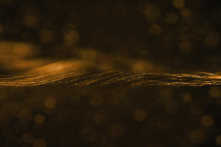 abstract 3D rendering frame digital glitter sparks golden particles with wave shape flowing on gold background, new technology conceptの写真素材