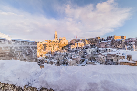 panoramic view of typical stones Sassi di Matera and church of Matera 2019 under blue sky with clouds and snow on the house, concept of travel and christmas holiday on snowflakes,capital of europe culture 2019の写真素材