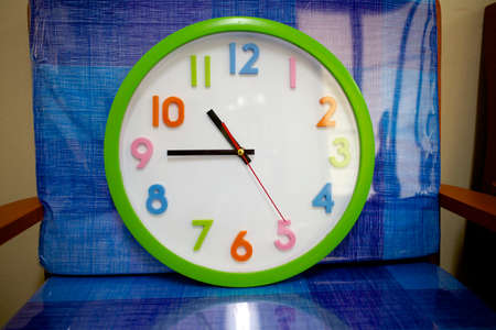 Colorful and round toy clock isolated