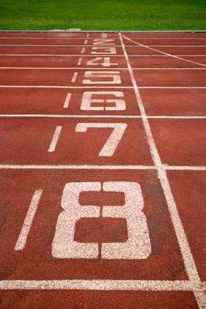 Red treadmill at the stadium with the numbering from one to eightの写真素材