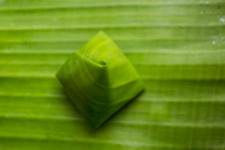 Thailand dessert wrapped in banana leaves.の写真素材