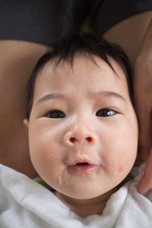 Asians eat babies mouth mess forced to eat.の写真素材