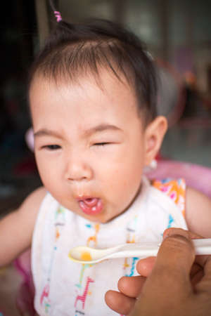 Asians eat orange juice mouth mess forced to eat の写真素材