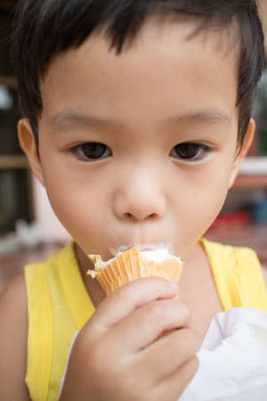 Asian children eating ice creamの写真素材