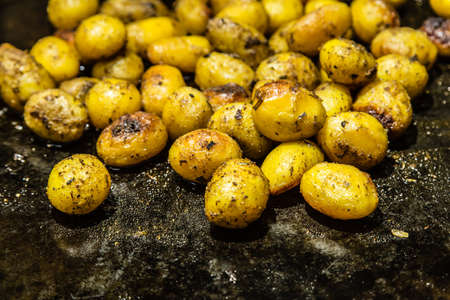 BBQ small potato on a black metal  plateの写真素材