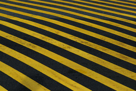 Striped black and yellow grunge background, warning signage.