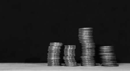 Close-up of a pile of coins on a black backgroundの写真素材