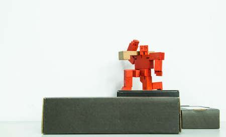 red wooden toy robot display on white backgroundの写真素材