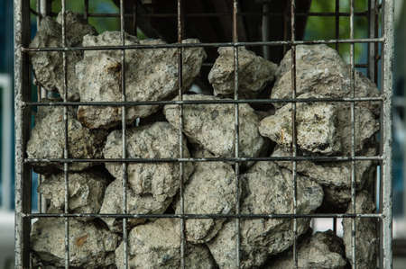 stone in metal cage landscape wallの写真素材