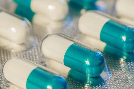 A panel of blue capsules medicine closeup macro viewの写真素材