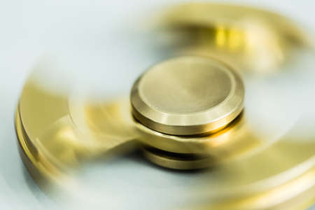golden color metal spinner toy closeup viewの写真素材