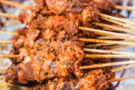 chinese style barbecue raw meat skewers closeup view