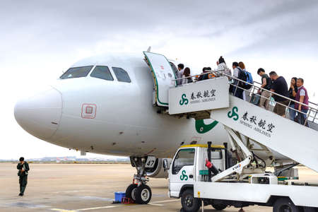 China,Shanghai-20 APR 2019:passenger boarding on airplane at Shanghai pudong international airportのeditorial素材