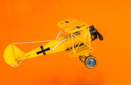metal air plane toy display on orange background