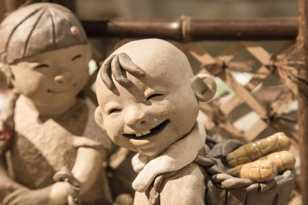 China,Suzhou-18 AUG 2017: smile face Pottery children boy figure closeupのeditorial素材