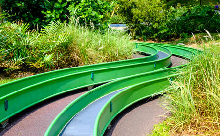 colorful long slide in public forest playgroundの写真素材