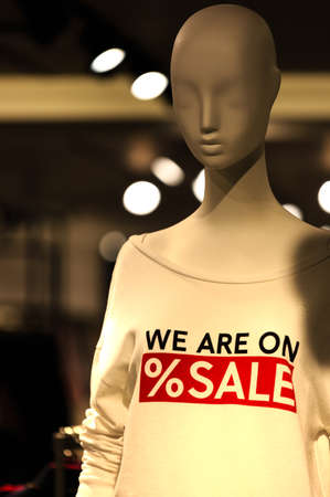 Part of male mannequin dressed in casual clothes with sale text