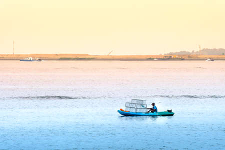 Singapore-29 JUN 2019: Fisherman is fishing in the sea by placing fishing cagesのeditorial素材