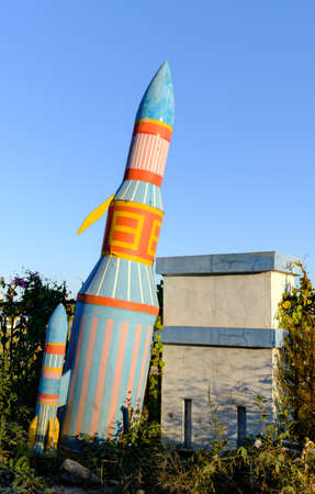 Hegang city, China-04 Oct 2018: abandon rocket toy in underbrush in blue skyのeditorial素材