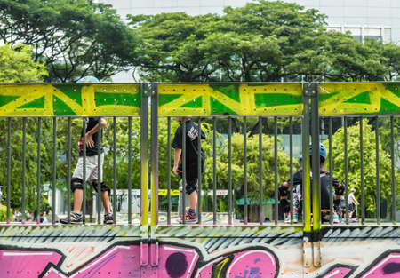 Singapore-08 OCT 2017:children play skateboard on outdoor open playgroundの写真素材