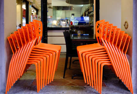 Singapore-14 APR: Piles of red color plastic chairs in restaurantの写真素材