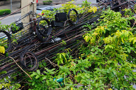 Bangkok,Thailand-01 APR 2018: Chaotic taggled mess of the electric power lines in the city of Bangkokの写真素材