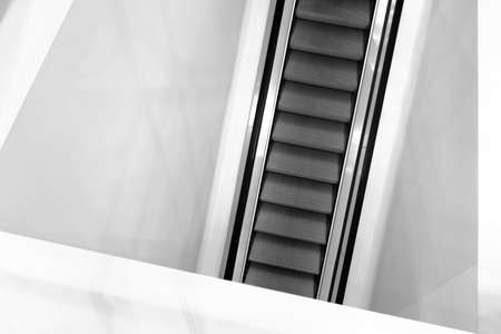 Escalator in white color wall,Moving up staircase. electric escalatorの写真素材