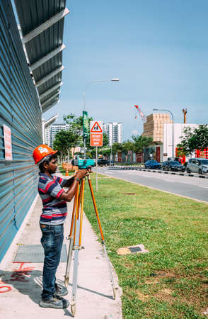 Singapore-16 JUN 2018: Indian surveyor worker is working on road side
