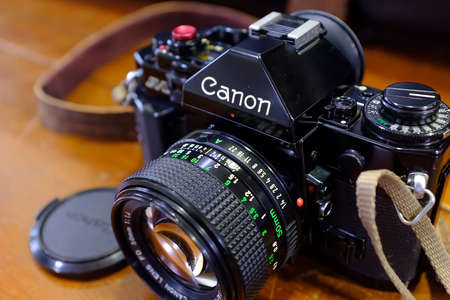 Singapore-03 MAR 2018: Canon AE-1 Vintage 50mm Film Camera on a wood Backgroundのeditorial素材