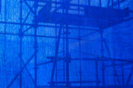 blue canvas covering the building Under construction