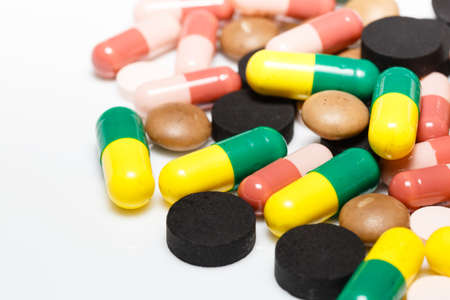 Various pills and capsules on white backgroundの写真素材