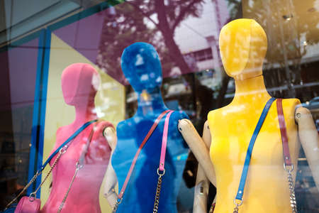 Female mannequins display inside a glass window