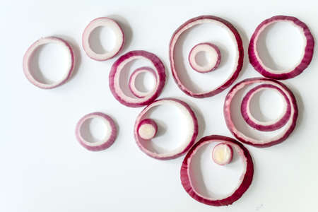Sliced red onion rings isolated on white background cutoutの写真素材