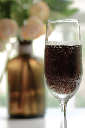 glass goblet with red drink display on tableの写真素材
