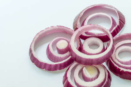 Sliced red onion rings isolated on white background cutoutの写真素材
