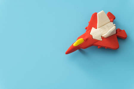 rubber fighter plane toy display on blue backgroundの写真素材