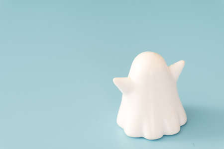 small white color plastic ghost figure in blue backgroundの写真素材
