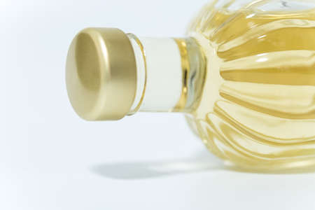 perfume bottle with yellow liquid isolated on whiteの写真素材