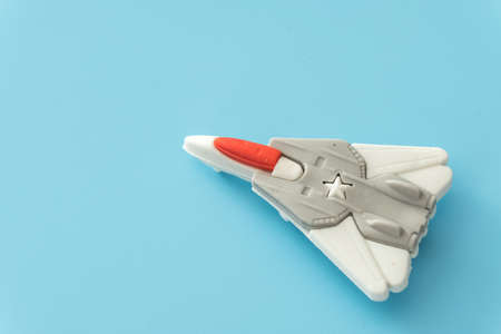 rubber fighter plane toy display on blue backgroundの写真素材