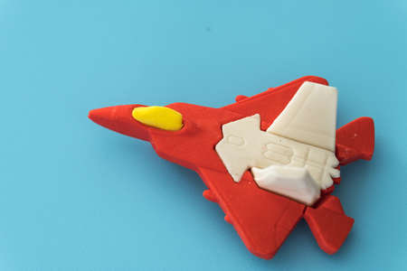 rubber fighter plane toy display on blue backgroundの写真素材