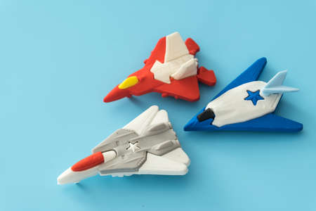 rubber fighter plane toy display on blue backgroundの写真素材