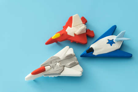 rubber fighter plane toy display on blue backgroundの素材 [FY310139795660]