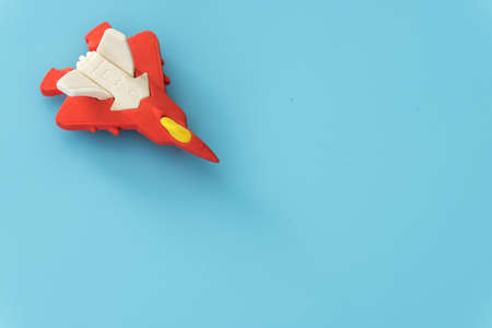 rubber fighter plane toy display on blue backgroundの写真素材