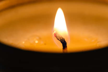 One candle flame at night closeup viewの写真素材