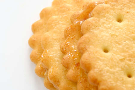 Stack of sweetmeal digestive biscuits isolated on whiteの写真素材