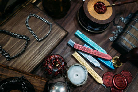 Stamps for sealing wax on an old textured gray tableの写真素材