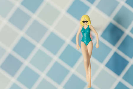 swimsuit Women plastic toy top view on blue backgroundの写真素材